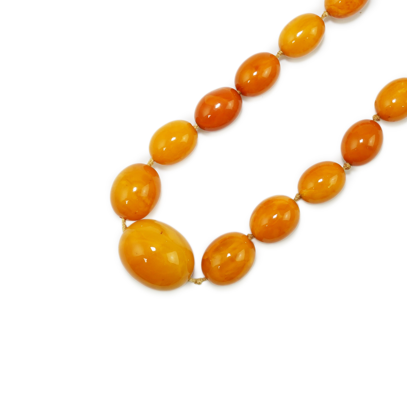 A single strand graduated oval amber bead necklace